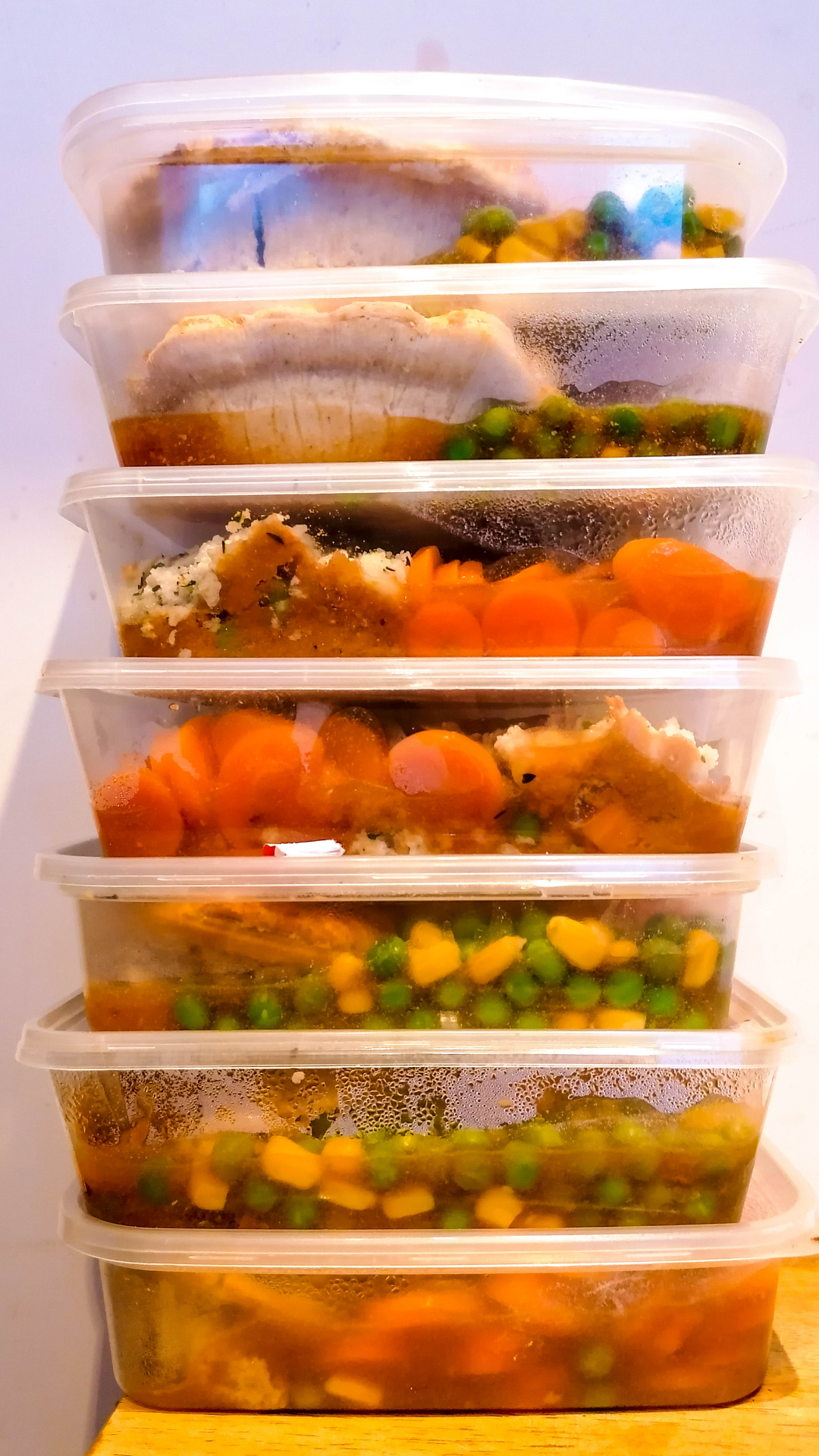 Premade meals stacked in a refrigerator