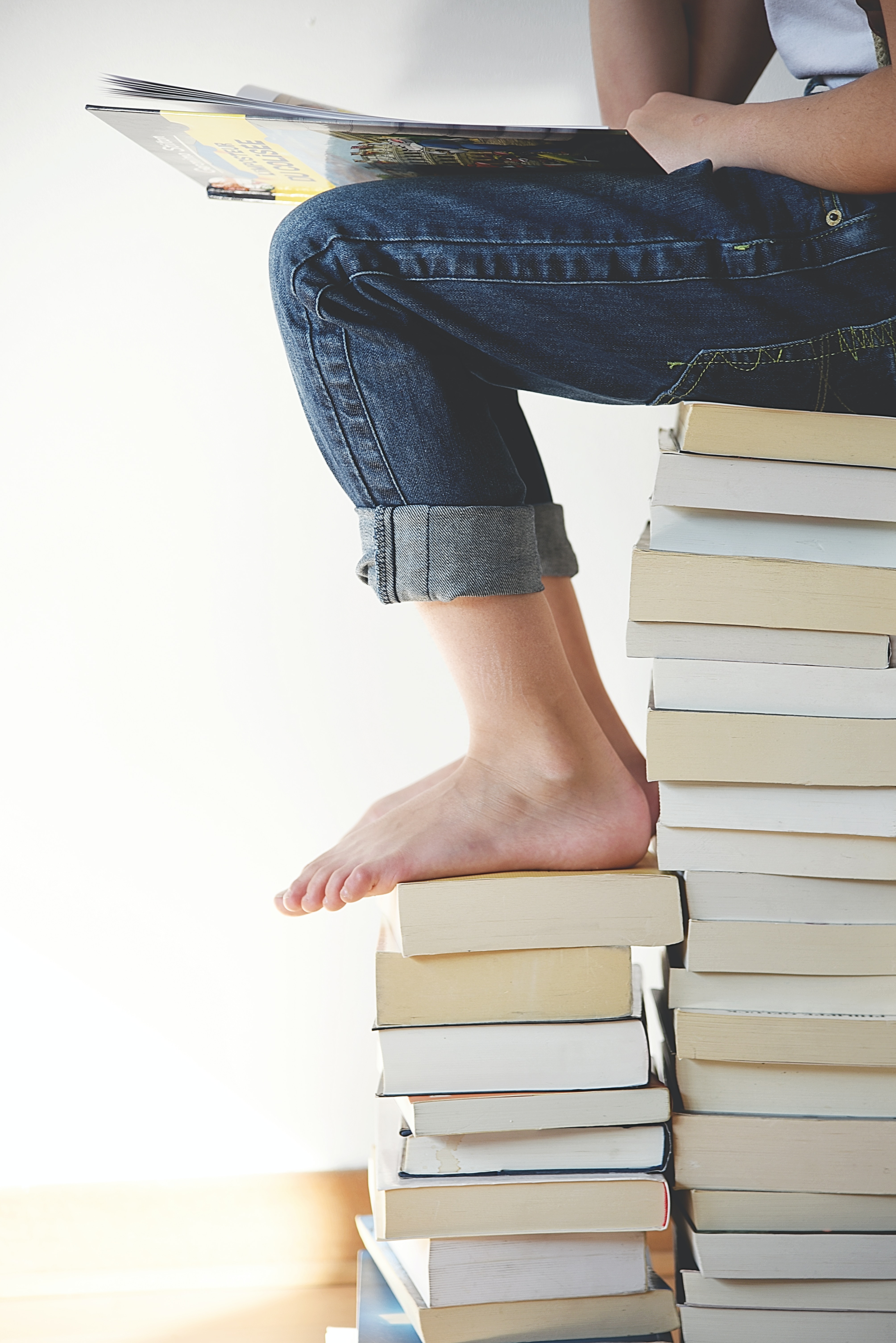 Child's feet on a stack of books